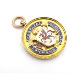 A 9ct gold fob medal with enamelled emblem of Rhymney Hospital Football Competition. Total weight