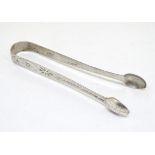 Geo III silver sugar tongs with bright cut decoration. Exeter c.1800 maker Richard Ferris. Approx