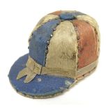 A 19thC novelty pin cushion formed as a jockey cap. Indistinctly marked under The Jockey Cap