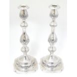 A pair of silver candlesticks with engraved decoration. Hallmarked London 1929 maker M.S. 14 1/2''