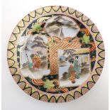 A Japanese plate with panelled decoration depicting Geisha girl style figures in a Japanese