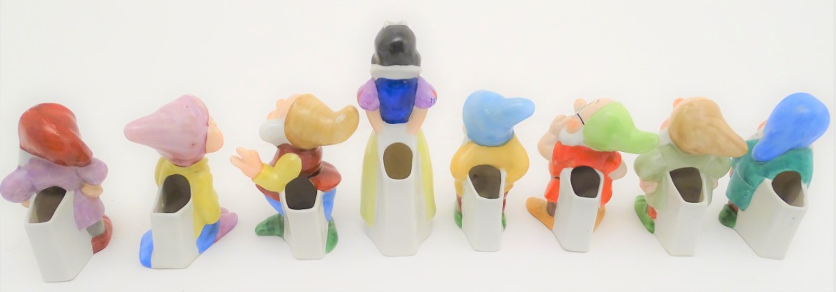 A mid-20thC ceramic novelty set of bud vases, formed as Snow White and the seven Dwarves. The - Image 9 of 9