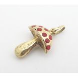 A 14ct (585) gold pendant / charm formed as a toadstool with red enamel decoration. Approx ¾" high