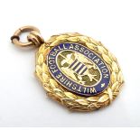 A 9ct gold fob medal with enamelled Wiltshire Football Association emblem. Total weight 8g Please