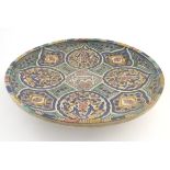 A Moroccan charger with panelled geometric designs with lotus and leaf shaped cartouches with