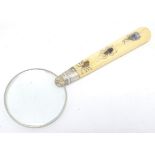 A later 19thC magnifying glass with hallmarked silver mounts. The handle decorated with inlaid