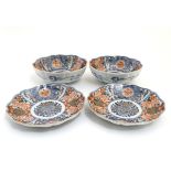 A pair of Japanese Imari plates and matching pair of bowls, having decorative floral and foliate