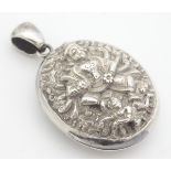 A late 19thC / early 20thC Anglo Indian white metal locket of oval pendant form with deity