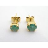 Gilt metal stud earrings set with green stones Please Note - we do not make reference to the