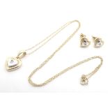A 9ct gold pendent and chain, the two colour gold pendant of heart shape set with central diamond,