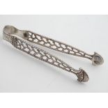 Late 18thC silver sugar tongs with cast decoration. Maker WC. 5 1/4" long Please Note - we do not