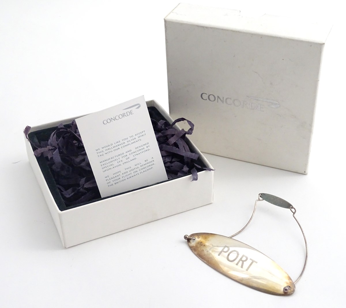 Concorde Memorabilia : A silver wine / decanter label / bottle ticked . Engraved ' Port'