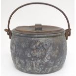 A Victorian stove top pot with a copper lid and a cast iron swing handle. Approx. 11" high. Please
