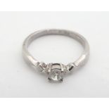 A silver ring set with paste stone solitaire. Ring size approx N Please Note - we do not make