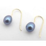 A pair of black freshwater pearl drop earrings with 14ct gold shanks. Approx 1/2" long Please Note -