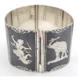A Sterling silver bracelet with 6 panels having niello style decoration depicting various Oriental