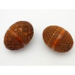 Two carved coquilla nut egg shape containers decorated with banded concentric circles. Approx. 2 1/
