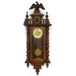 An early 20thC regulator wall clock, the carved mahogany and pine case with glazed door,