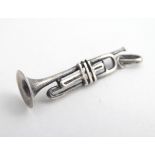 A silver pendant charm formed as a trumpet 1 1/4" long Please Note - we do not make reference to the