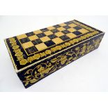 A 19thC games box with penwork scrolling flower decoration to sides, a chess / draughts / checkers