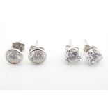 Two pairs of silver stud earrings set with cubic zirconia. (2+2) Please Note - we do not make