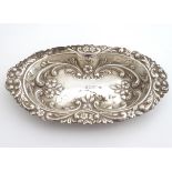 A silver dish with embossed decoration hallmarked London 1984 maker BJS. 5 1/2" wide. (30g) Please