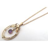 A 9ct gold pendant and chain, the pendant set with amethyst and seed pearls. 1 1/4" long. Please