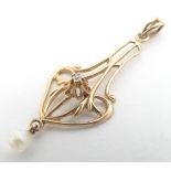 A 14ct gold pendant set with central diamond and pearl drop. Approx 1 1/2"long Please Note - we do