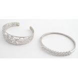 Two silver bracelets of bangle form set with cubic zirconia. Please Note - we do not make