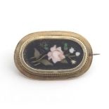 Grand Tour jewellery : A 19thC brooch with pietra dura floral decoration detail within a yellow