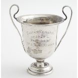 A silver twin handled trophy cup engraved ' Egham Regatta 1925...' Hallmarked London 1925 maker