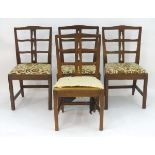 A set of four oak dining chairs by Arthur Romney Green with pierced back rests and drop in seats,