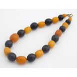 A vintage bead necklace comprising dark and butterscotch coloured beads. 14" long Please Note - we