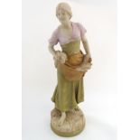 A large Royal Dux figurine modelled as a young woman / maiden carrying wheat sheaves. Raised on a