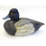 A 21stC American life-sized hand carved, hand painted wooden decoy duck, with inset glass eyes,