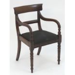 A mid 19thC mahogany open armchair with a shaped top rail and mid rail above a drop in seat and