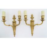 A pair of gilt metal twin branch wall sconces with flaming urn decoration. Together with four