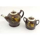 A Royal Doulton Kingsware teapot and twin handled sugar bowl decorated with figures drinking tea