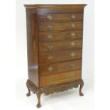 A mahogany Irish chest on stand with a moulded cornice above a blind fretwork carved frieze, the