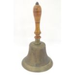 A 19th / 20thC large hand bell with a turned wooden handle and incised banded decoration. Approx. 14
