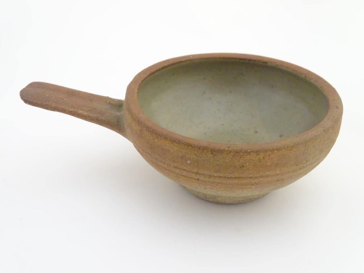 A Leach Pottery, St. Ives, stoneware egg baker / ramekin with a single handle. Impressed studio