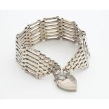 A silver wide chain link bracelet with padlock clasp. Approx 7" long Please Note - we do not make