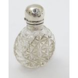 A small cut glass scent / perfume bottle with silver mount hallmarked Birmingham 1907. 2" high