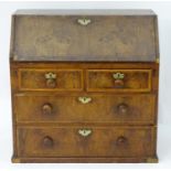 An early / mid 17thC walnut bureau with a cross banded fall front and drawers, comprising two