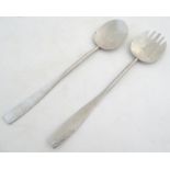 A pair of Keswick School of Industrial Arts, KSIA, stainless steel salad servers with hammered