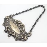 A silver decanter label / bottle ticket of escutcheon shape, marked Whiskey, hallmarked Chester