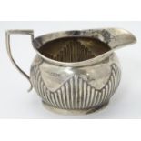 A silver cream jug hallmarked Sheffield 1902 maker Mappin & Webb 3 1/4" high (174g) Please Note - we