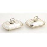 A matched pair of silver entree dishes and covers, hallmarked London 1918 and 1921, maker Charles