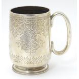 A Victorian silver Christening mug with engraved decoration . Hallmarked London 1877 maker WE. 4"