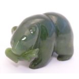 A green jade carving formed as a bear with a fish in its mouth. Approx. 2" long. Please Note - we do